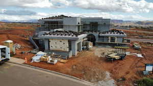 View of front of property featuring stone siding, a mountain view, and stucco siding