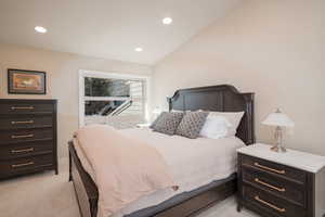 Main Bedroom featuring recessed lighting, light carpet, and vaulted ceiling