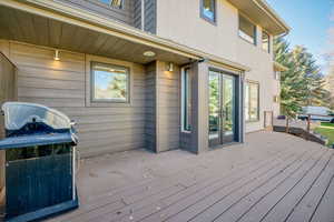 Wooden terrace featuring grilling area and french doors
