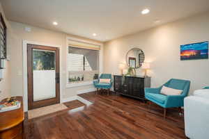 Sitting room featuring recessed lighting and dark wood-style flooring