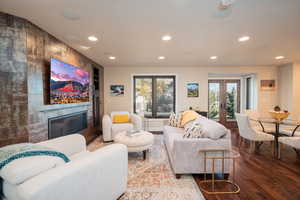 Living room featuring wood finished floors, recessed lighting, and a fireplace