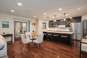 Dining room with recessed lighting, dark wood-style flooring, and french doors