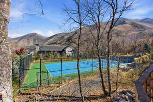 View of tennis court with a mountain view