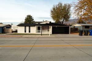 Ranch-style home featuring concrete driveway and an attached garage