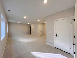 Spare room with light carpet and recessed lighting