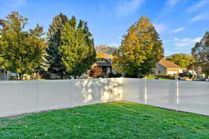 Fenced backyard featuring a mountain view