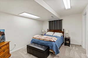 Bedroom featuring light carpet and a textured ceiling