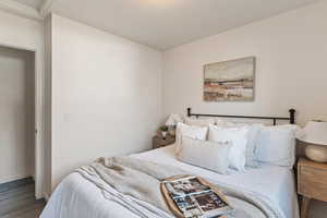 Bedroom featuring wood finished floors and baseboards