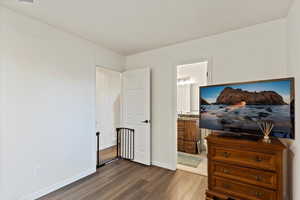 Bedroom with wood finished floors and ensuite bathroom