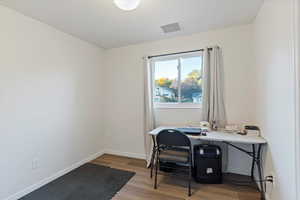 Office area featuring wood finished floors and baseboards
