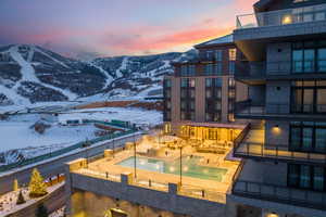 Exterior space featuring a mountain view, a fenced backyard, and a hot tub