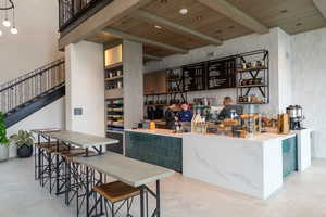 Bar featuring open shelves, a wood ceiling with exposed beams, a towering ceiling, stairway, and green cabinetry