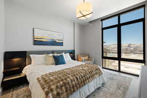 Bedroom with floor to ceiling windows, a mountain view, and wood finished floors