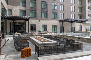 View of patio / terrace with a pergola and an outdoor living space with a fire pit
