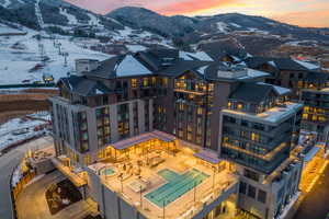 Aerial view at dusk of a mountain view and view of pool