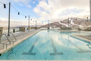 Community pool featuring a mountain view and a patio