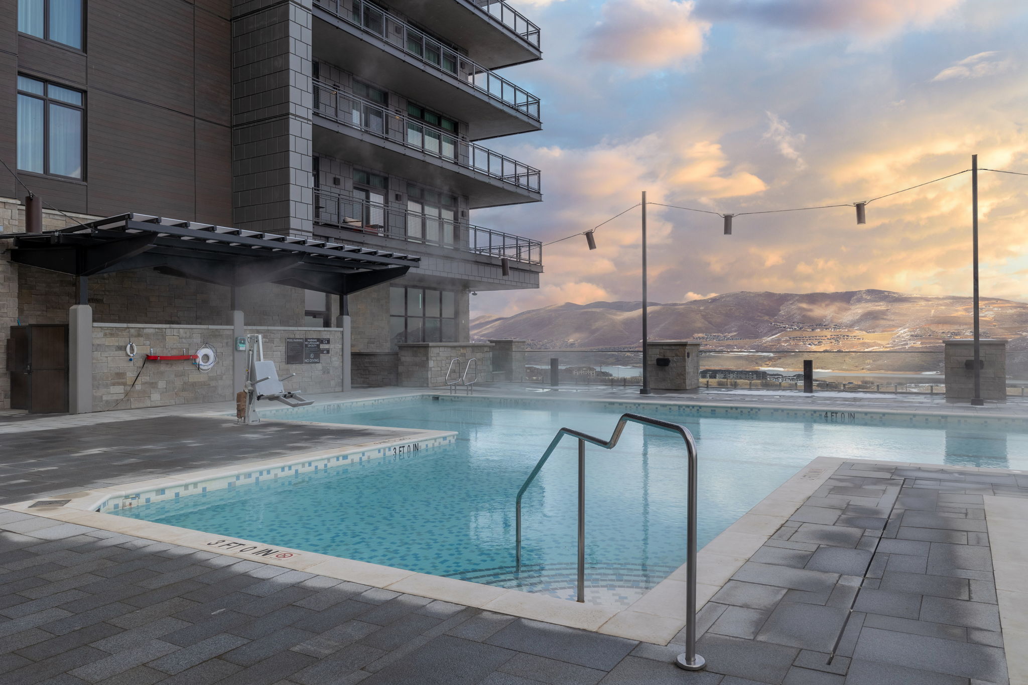 Pool at dusk featuring a community pool and a mountain view