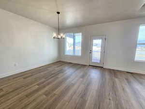Unfurnished dining area featuring light wood-style floors and a chandelier