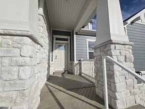 Entrance to property with stone siding