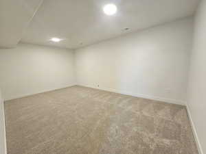 Spare room featuring light carpet and recessed lighting