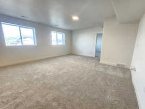 Carpeted spare room with baseboards