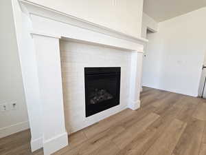 Detailed view of a fireplace and wood finished floors