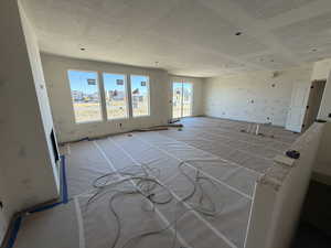 Spare room featuring a textured ceiling and wallpapered walls