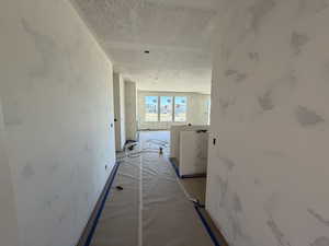 Hall with a textured ceiling