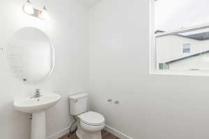 Bathroom featuring baseboards and wood finished floors