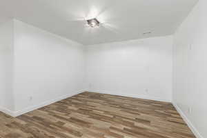 Spare room featuring dark wood-style floors and a textured ceiling