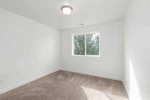 Empty room with carpet floors and baseboards