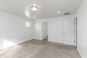Unfurnished bedroom featuring light colored carpet and recessed lighting