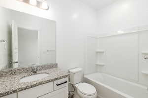 Full bath with vanity and shower / bath combination