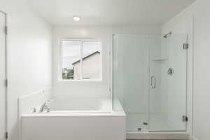 Bathroom with a bath and a shower stall