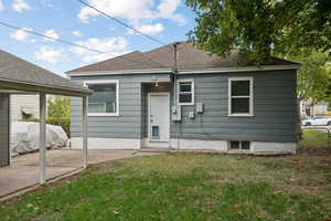 Back of property with roof with shingles
