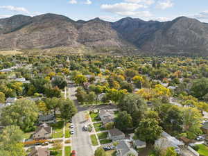 Aerial view of property's location with nearby suburban area and a mountainous background
