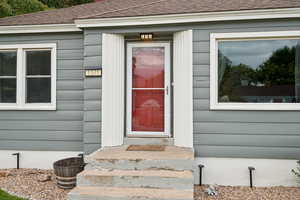 Property entrance with a shingled roof