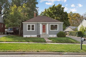 Bungalow-style house with roof with shingles and a chimney