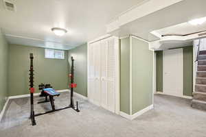 Workout area featuring carpet floors and baseboards