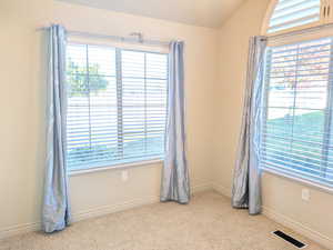Unfurnished room featuring light colored carpet and baseboards