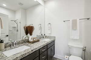 Bathroom with a shower stall and double vanity