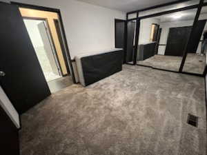 Unfurnished bedroom with carpet flooring and a closet