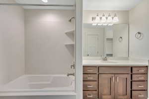 Full bath featuring vanity and shower / bathtub combination