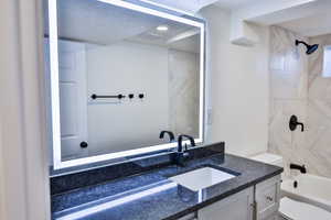 Full bathroom featuring shower / bath combination and vanity