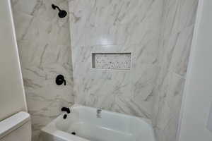 Full bathroom featuring shower / bathtub combination and toilet