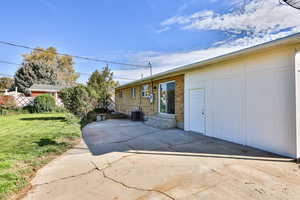 Back of house with a patio, a yard, entry steps, and brick siding