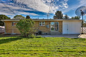 Rear view of property featuring a patio, brick siding, and entry steps