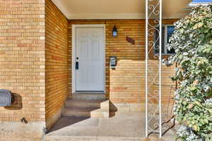 Entrance to property featuring brick siding