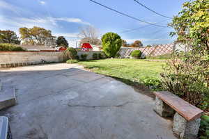 Fenced backyard with a patio
