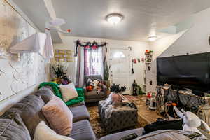 Tiled living area with a textured ceiling
